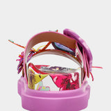 Colorful pink sandal with floral design and embellishments heel view