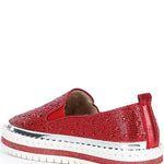 Red bejeweled slip-on shoe with a white sole inner side view