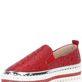 Red bejeweled slip-on shoe with a white sole front view