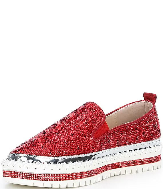 Red bejeweled slip-on shoe with a white sole front view