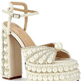 Elegant high-heeled shoe with pearl embellishments front view