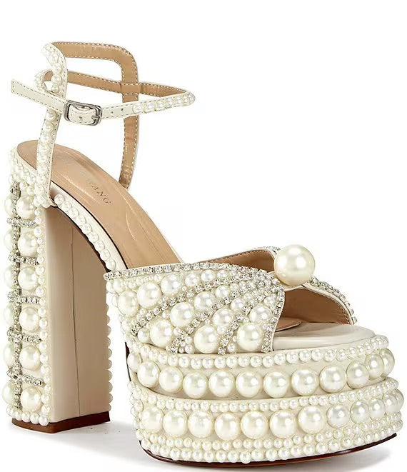 Elegant high-heeled shoe with pearl embellishments front view