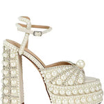 Elegant high-heeled shoe with pearl embellishments lose-up