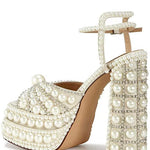 Elegant high-heeled shoe with pearl embellishments inner side view