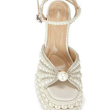 Elegant high-heeled shoe with pearl embellishments front view