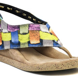Colorful woven sandal with a black strap close-up front view