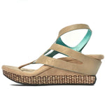 Wedge sandal with beige straps side view