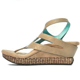 Wedge sandal with beige straps side view
