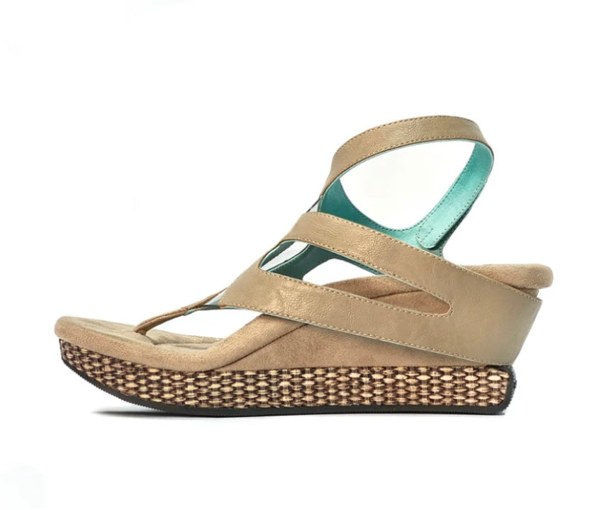 Wedge sandal with beige straps side view