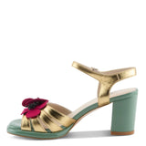 Open toe heeled shoe with gold strap, green sole, tan toe strap and raspberry flower side view