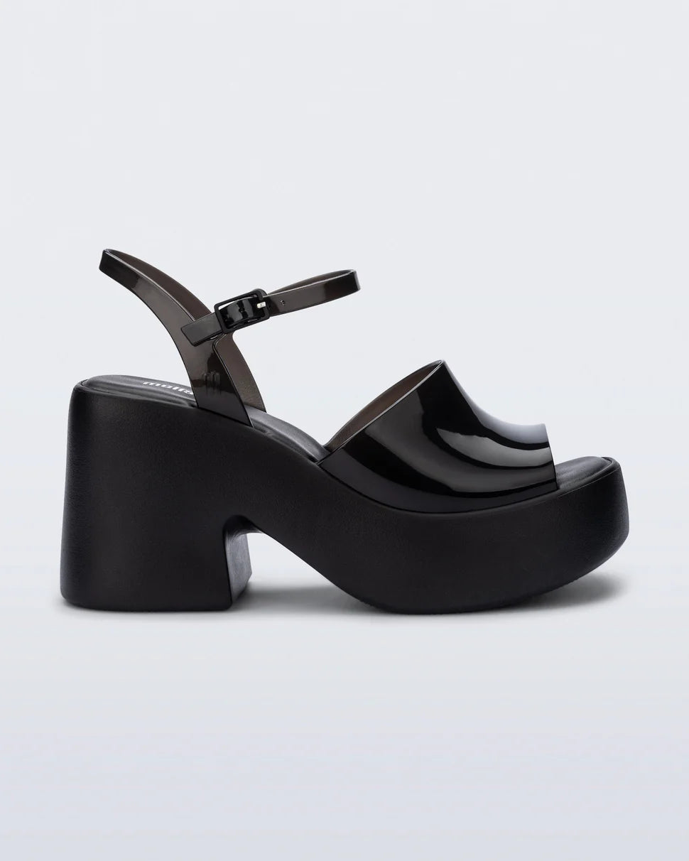Black platform heels with black strap & buckle closure close-up