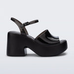 Black platform heels with black strap & buckle closure close-up