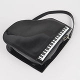 Black grand piano handbag with black strap close-up