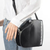Black grand piano handbag with black strap model