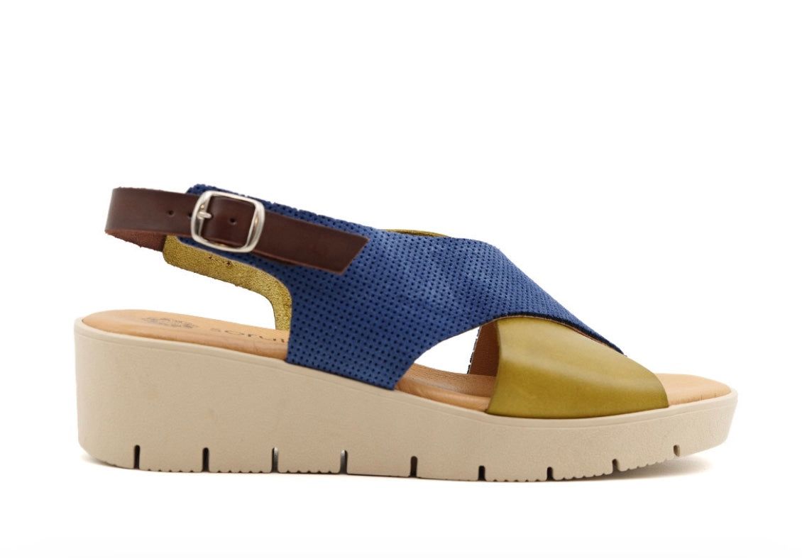 Blue and green wedge with a beige sole, brown heel strap and buckle closure close-up