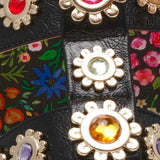 Floral sandal with colorful jewel embellishments and green heel detail view