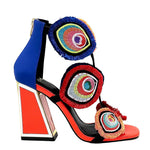 Colorful large heel with three peacock feather elements and zipper closure close-up