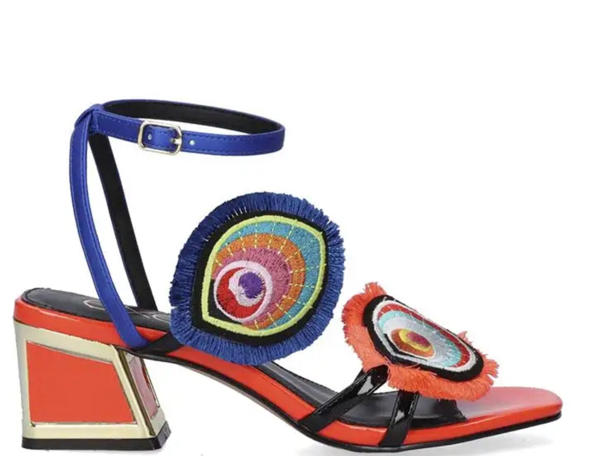 Colorful heel with peacock feather elements and blue strap buckle closure close-up