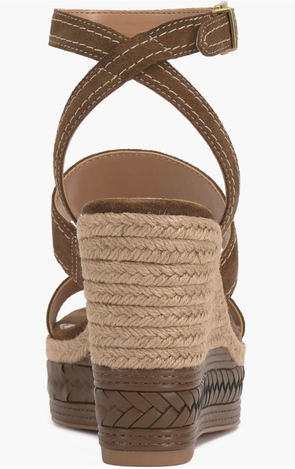 Brown wedge sandal with espadrille sole and buckle closure heel view