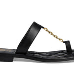 Black sandal with a gold chain with small heel close-up
