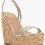 Beige wedge sandal with gold metallic straps and buckle closure side view