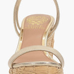 Beige wedge sandal with gold metallic straps and buckle closure front view