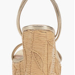 Beige wedge sandal with gold metallic straps and buckle closure heel view