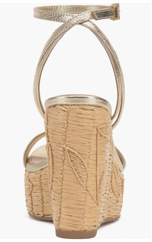 Beige wedge sandal with gold metallic straps and buckle closure heel view