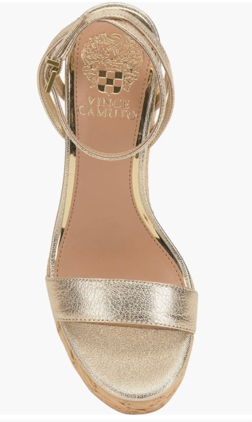 Beige wedge sandal with gold metallic straps and buckle closure overhead