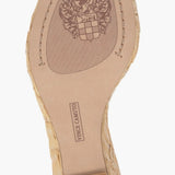 Beige wedge sandal with gold metallic straps and buckle closure bottom view