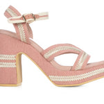 Pink heel with woven white straps close-up