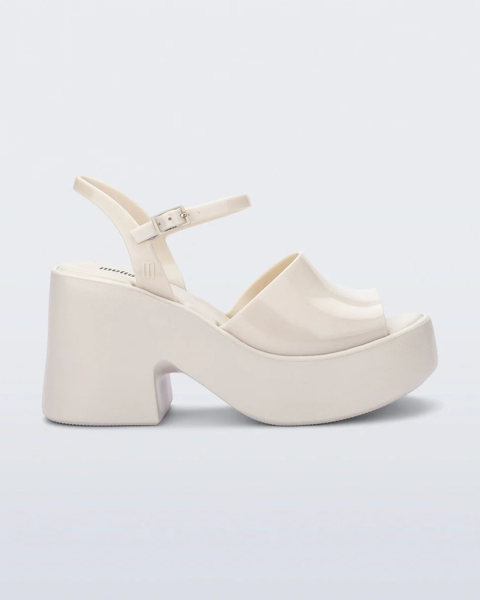 White platform heel with white strap and buckle closure close-up