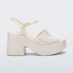 White platform heel with white strap and buckle closure close-up
