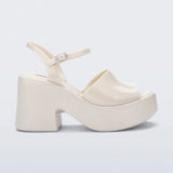 White platform heel with white strap and buckle closure close-up