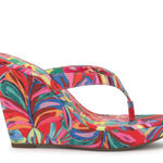 Colorful wedge sandal with a vibrant paint inspired floral pattern close up