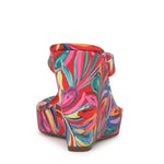 Colorful wedge sandal with a vibrant paint inspired floral pattern from back