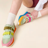 Multicolored velcro sneaker with orange sole pair