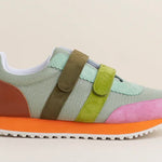 Multicolored velcro sneaker with orange sole close-up
