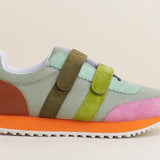 Multicolored velcro sneaker with orange sole close-up