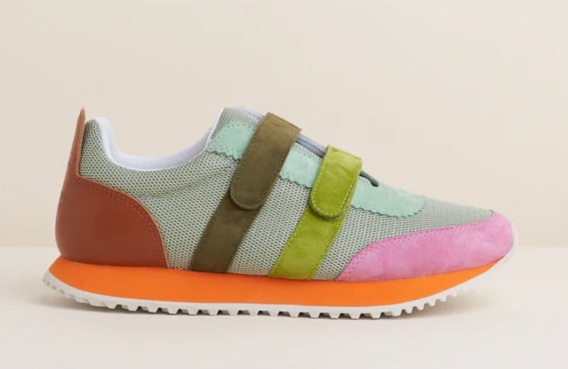 Multicolored velcro sneaker with orange sole close-up