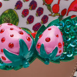 close up of strawberry embellishment on betsey johnson sandal 