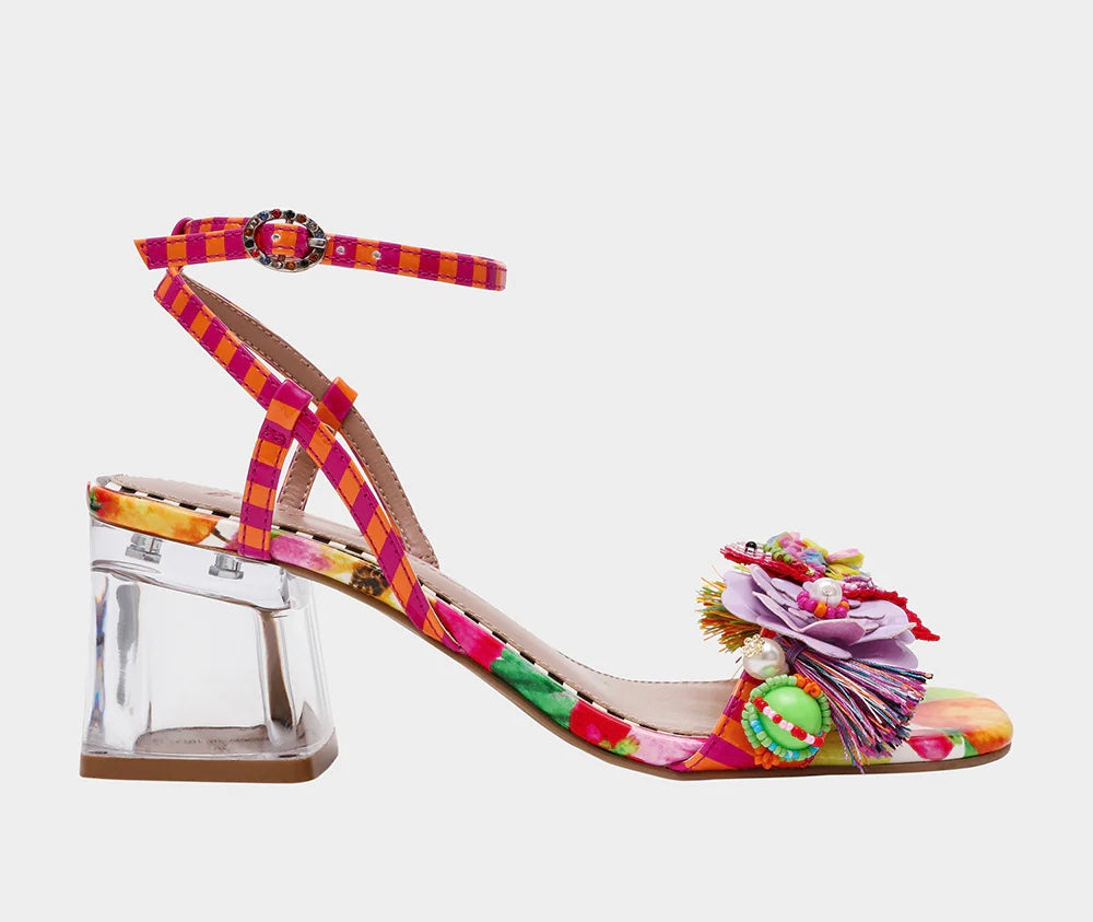 Colorful sandal with floral design, ankle strap, floral applique, and a clear heel close up