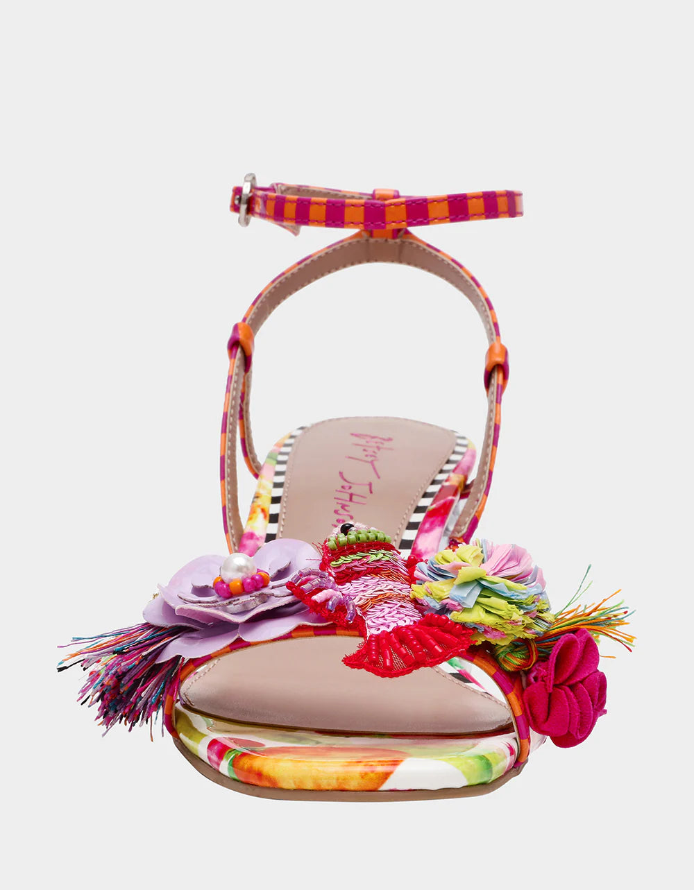Colorful sandal with floral design, ankle strap, floral applique, and a clear heel from front
