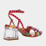 Colorful sandal with floral design, ankle strap, floral applique, and a clear heel from side back
