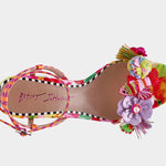 Colorful sandal with floral design, ankle strap, floral applique, and a clear heel birds eye view