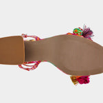 Colorful sandal with floral design, ankle strap, floral applique, and a clear heel from bottom
