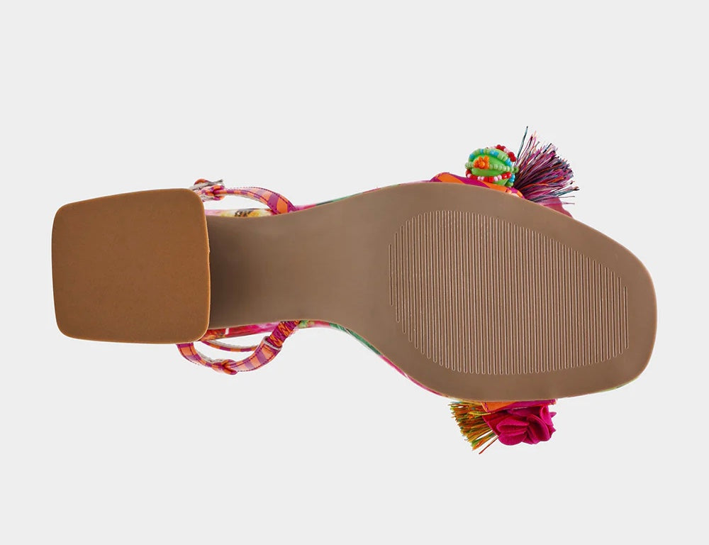 Colorful sandal with floral design, ankle strap, floral applique, and a clear heel from bottom