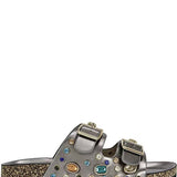 Silver sandal with gemstone embellishments on a white background
