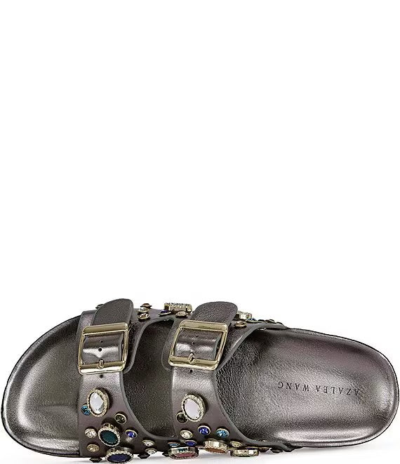 Silver sandals with embellishments on a white background