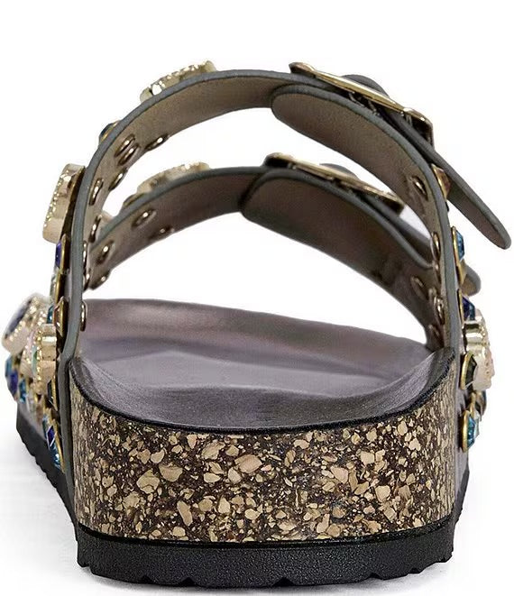 Close-up of a sandal with embellishments on a white background